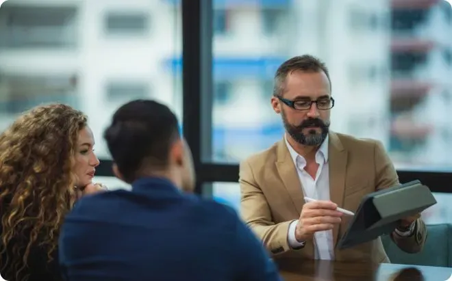 Man presenting data to a couple.