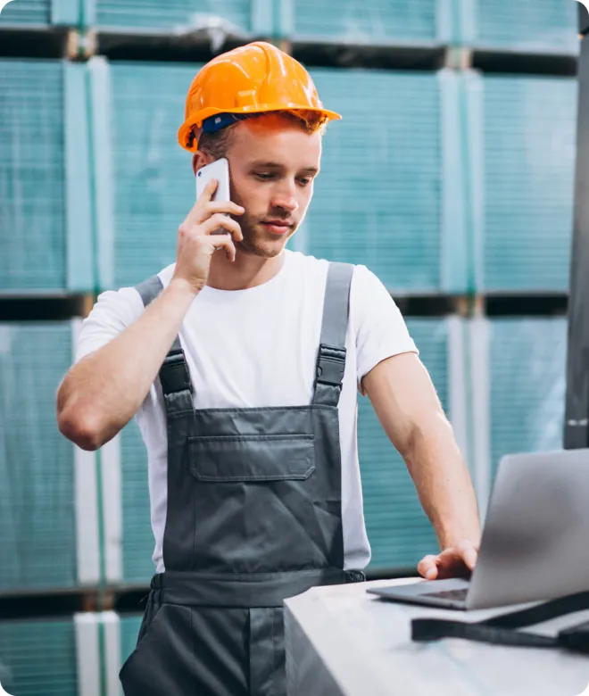 Man on a cell phone wearing PPE.