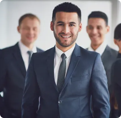 Three men in suits smiling.