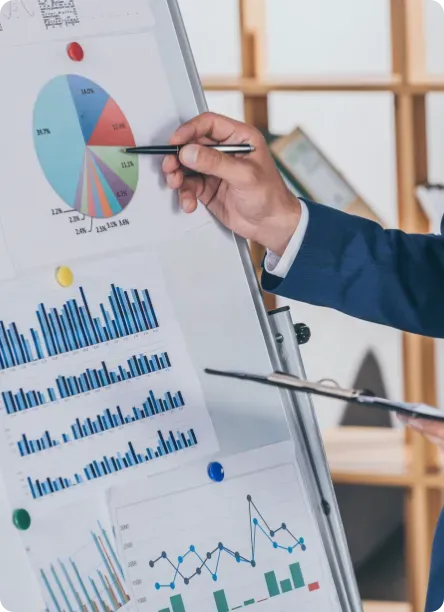 Business man presenting a chart on a whitboard.