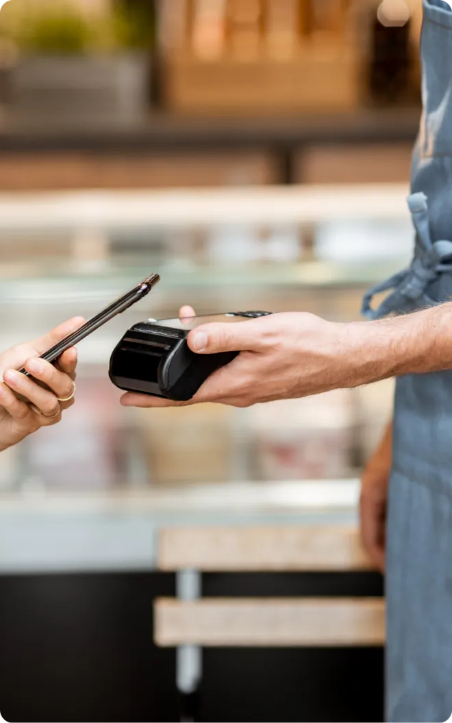 Customer tapping cell phone to pay.
