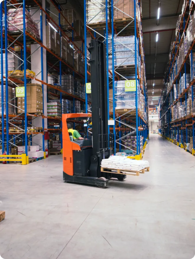 Orange forklift in a warehouse.