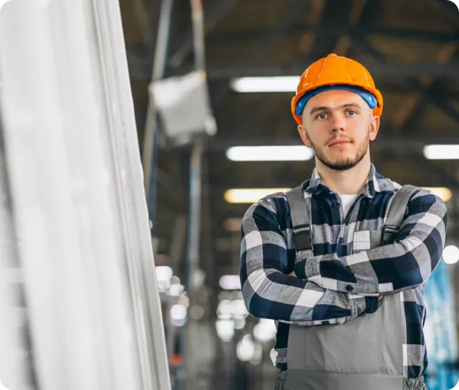 Man in a warehouse wearing PPE.