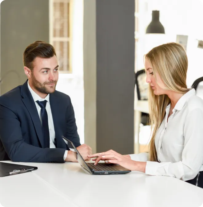 Man and woman using a laptop.