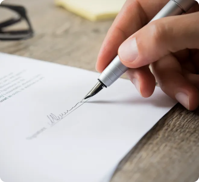 Man signing a contract.