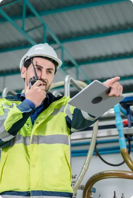 Man on a radio holding a tablet pointing.