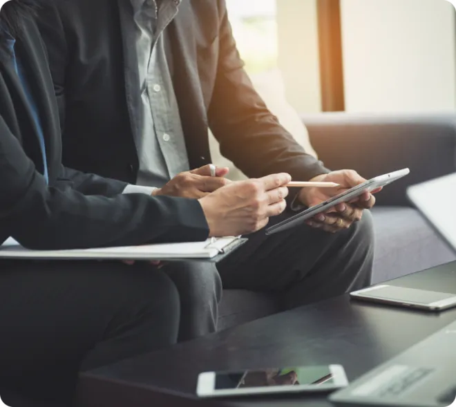 Businessmen using a tablet.