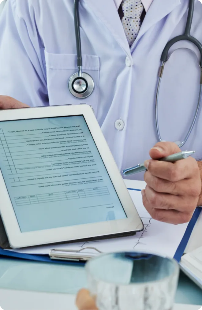 Doctor reviewing data on a tablet.
