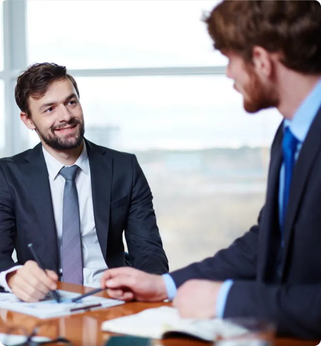 Two men working at a desk.